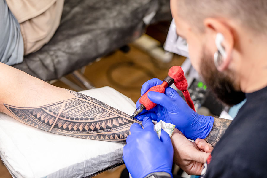 Tattoo artist wearing gloves