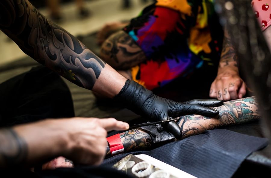 Artist performing innovative tattoo technique