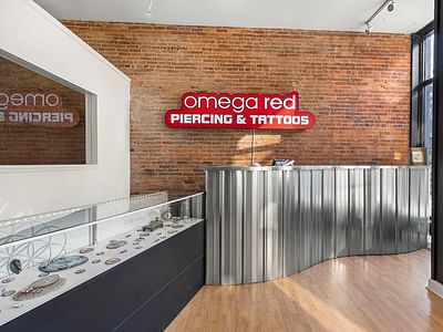Omega Red Piercing & Tattoo