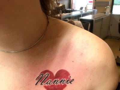 Sin on skin tattoo and piercing