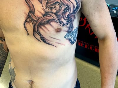 Sin on skin tattoo and piercing