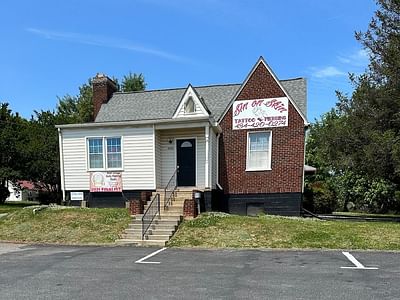 Sin on skin tattoo and piercing