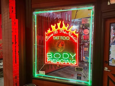 Slave to the Needle Tattoo & Body Piercing